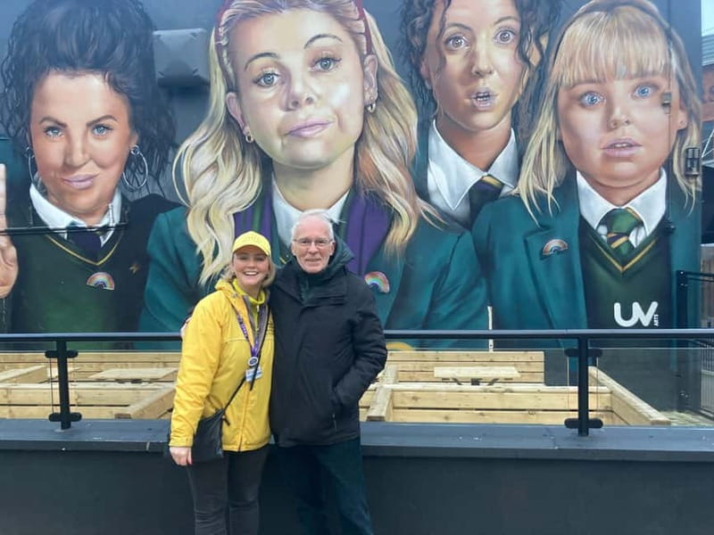 Derry: Guided Derry Girls TV Show Public Tour - Finding the meeting point: Badgers Bar mural, guide in yellow